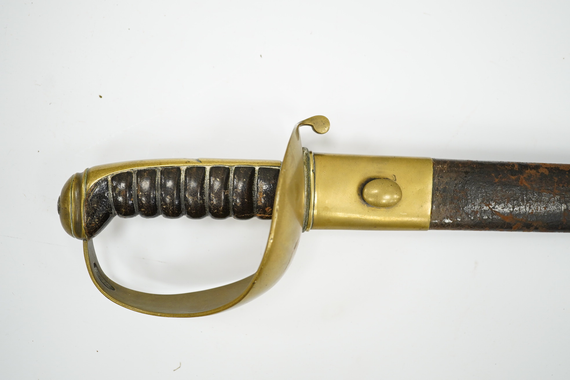 A late 19th century boarding cutlass with plain blade, plain brass guards and mounts, and leather covered grip, in its brass mounted leather scabbard (the chape is an associated replacement). Condition - fair